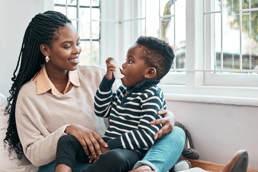 Mother helping her son with an inhaler