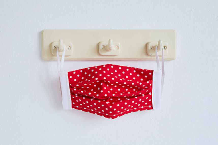 Face mask hanging on wall hooks.