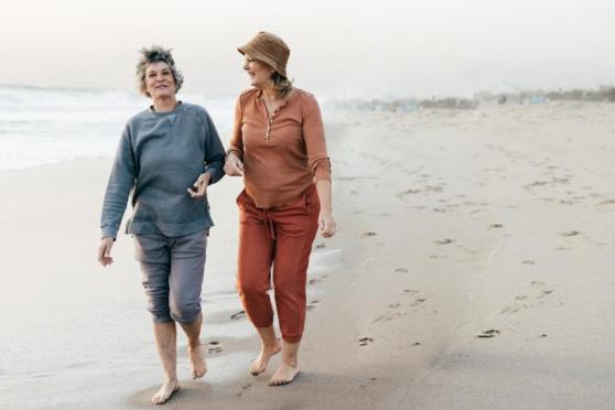 Two women walking on the beach