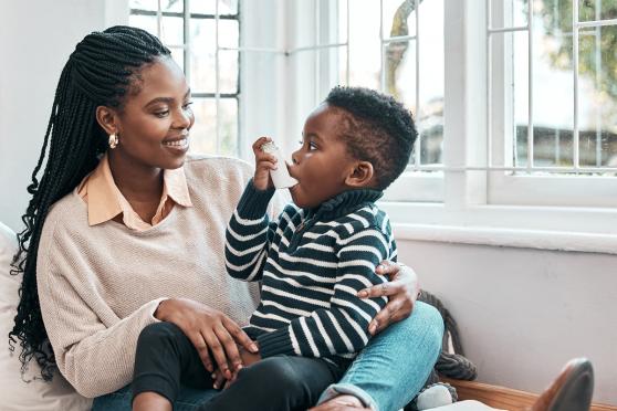Mother helping her son with an inhaler
