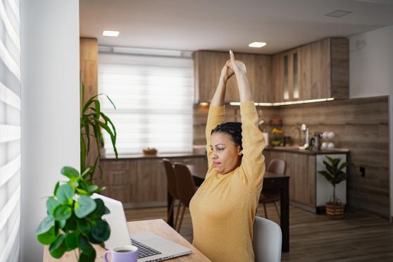 Woman stretching at her desk